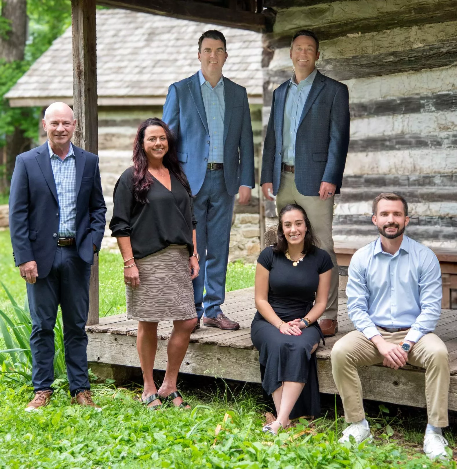 The One Private Wealth team of financial advisors poses by a cabin not far from their office in Chesterfield, MO